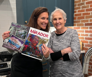 A picture of a woman and her daughter holding a magazine